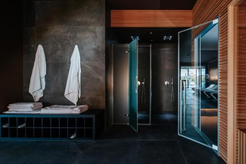 a bathroom with a shower and a glass door at JO Hotel in Marano Lagunare