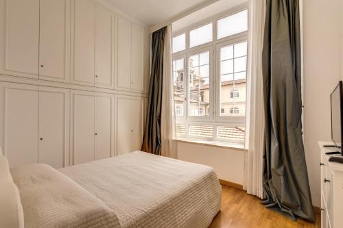 a bedroom with a bed and a window at Apollo Apartments Colosseo in Rome