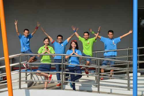 a group of people standing on a railing at POP! Hotel Kelapa Gading in Jakarta