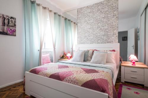 カルダス・ダ・ライーニャにあるDream City Homeのレンガの壁、ベッド付きのベッドルーム1室