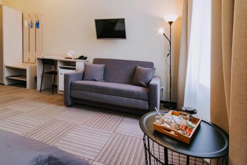 a living room with a couch and a table at Nevsky Grand Apartments in Saint Petersburg