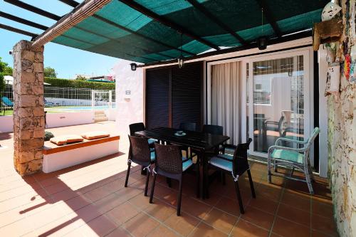 a patio with a table and chairs on a deck at LOTUS VILLA, Albufeira in Albufeira