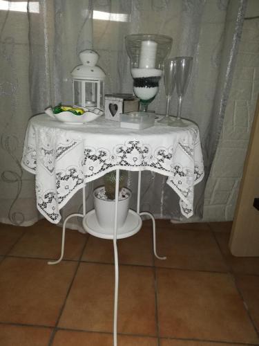 a table with a white table cloth on it at b&b ERCOLANO Scavi in Ercolano