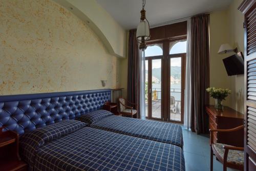 Postel nebo postele na pokoji v ubytování Hotel Malcesine