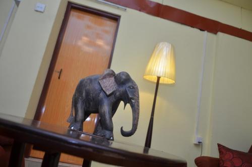 a statue of an elephant on a table next to a lamp at Villa Eco Green Airport in Katunayake