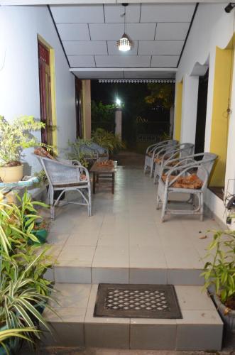 a patio with chairs and tables in a building at Villa Eco Green Airport in Katunayake