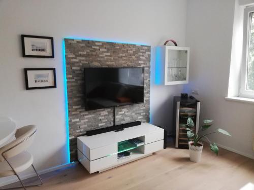 a living room with a tv on a brick wall at Apartment Meschnik in Graz