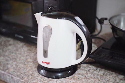 a white toaster sitting on a counter next to a microwave at RQS Hostel in Tacloban