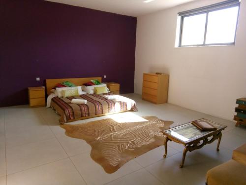 a bedroom with a bed and a table in a room at Sliema La Loggia Suites in Sliema