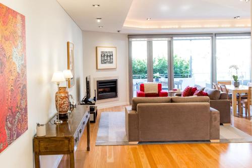 a living room with a couch and a fireplace at Constellation Apartments in Margaret River Town