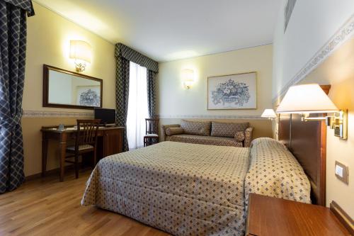 Postel nebo postele na pokoji v ubytování Albergo Il Cacciatore