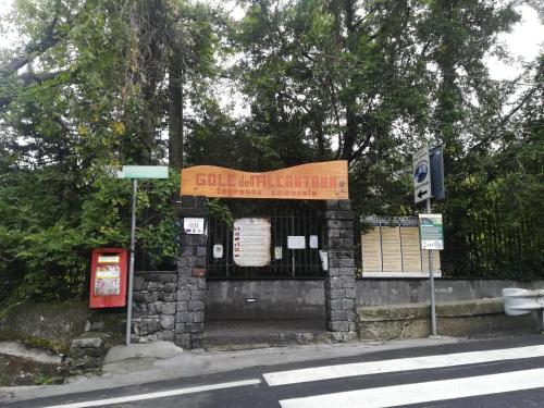 a building with a sign on the side of a street at Cottage Gole Alcantara Gloria Room in Graniti