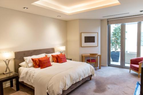 a bedroom with a large bed with red pillows at Constellation Apartments in Margaret River Town