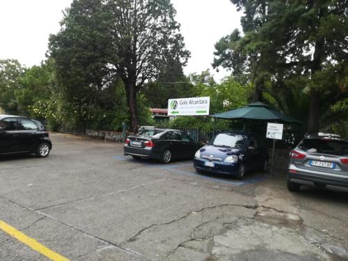a group of cars parked in a parking lot at Cottage Gole Alcantara Gloria Room in Graniti