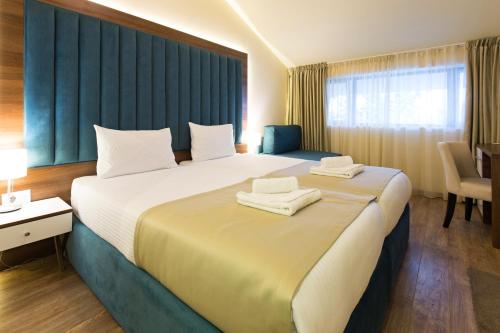 Postel nebo postele na pokoji v ubytování Marquise Hotel Garni