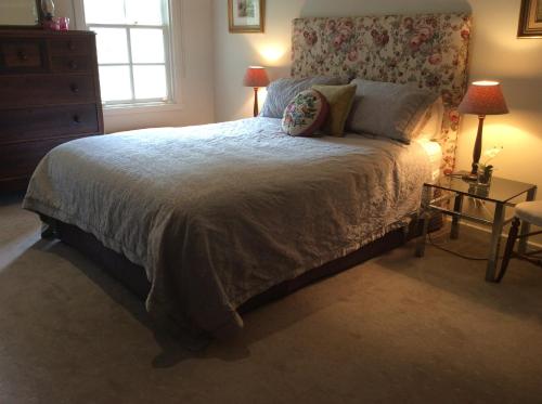 a bedroom with a large bed and a window at Hollyoak in Trentham