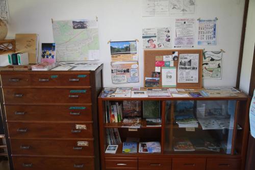 a room with a dresser and a book shelf at Guest House Yukari in Tsuru 
