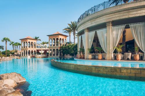a resort with a swimming pool and a building at JOIA El Mirador by Iberostar -Adults Only in Adeje