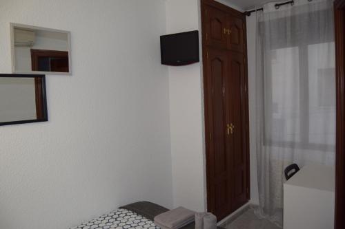 Телевизор и/или развлекательный центр в Hostal Rofer