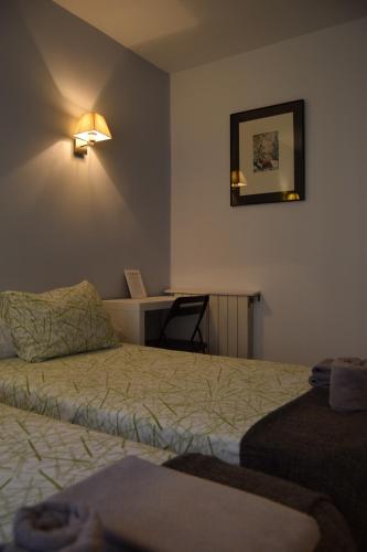 A bed or beds in a room at Hostal Rofer