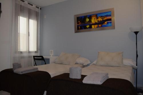 Кровать или кровати в номере Hostal Rofer
