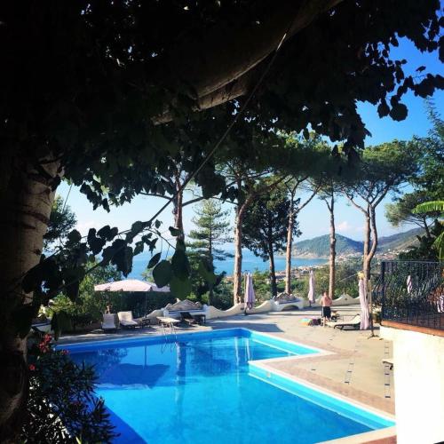 a swimming pool with a view of the ocean at Hotel Garden Riviera in Santa Maria di Castellabate