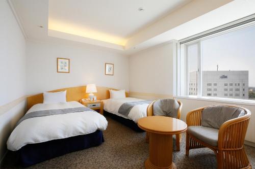 Giường trong phòng chung tại Hotel Kyocera