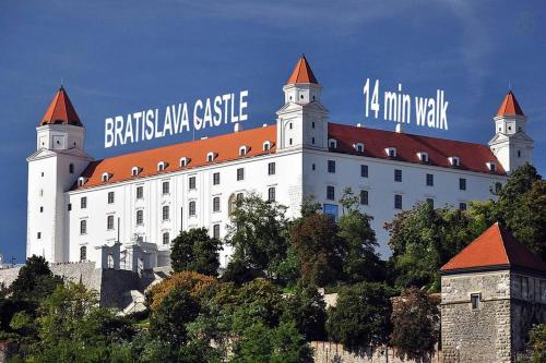 een groot wit gebouw met een bord erop bij Charming Apartment in Paradise called Bratislava in Bratislava