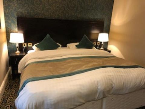 A bed or beds in a room at Globe Hotel Wetherspoon 