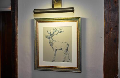a drawing of a deer on a wall at White Hart Hotel by Greene King Inns in Coggeshall