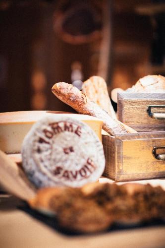 a table topped with bread and a cup of coffee at Hôtel L'Arboisie in Megève