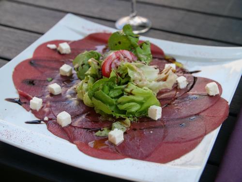 a plate of food with meat and vegetables on it at Hôtel Inn Design Resto Novo Langres in Langres
