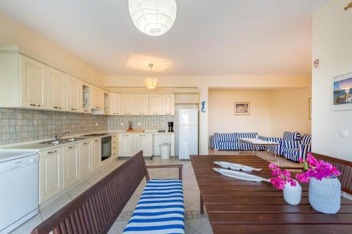 a kitchen with a table and chairs in a room at Kissakas Villas in Leonidion