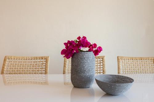 a vase with red flowers sitting on a table at Kissakas Villas in Leonidion