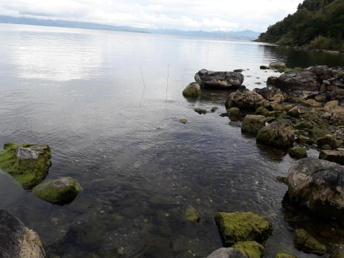 a large body of water with rocks in it at Pondok Berata Dapdap in Balige