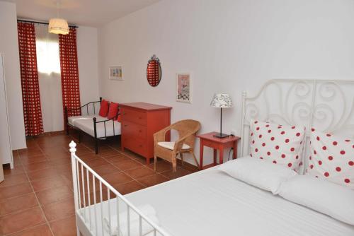 a bedroom with a bed and a desk and a chair at Country Villas in Stelida