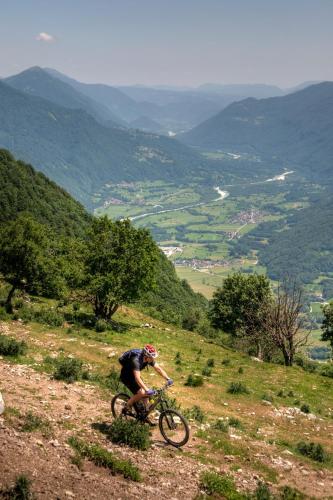 a person riding a bike on a hill at Kamp Koren Kobarid in Kobarid