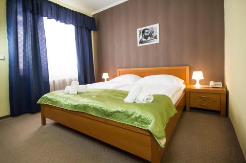 a bedroom with a bed and a lamp at Film Hotel in Bratislava