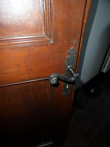 a wooden door with a metal door knocker on it at Stephanie Home in Padova