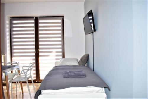 Un pat sau paturi într-o cameră la Apartament Fibra Cappuccino