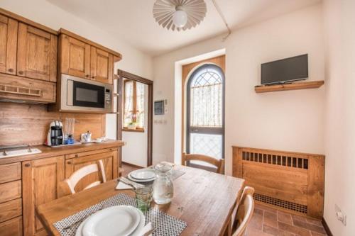 a kitchen with a wooden table and a dining room at Villa Ghiandai in Arezzo