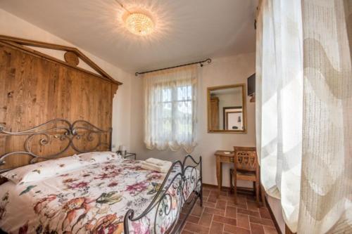 a bedroom with a large bed and a window at Villa Ghiandai in Arezzo