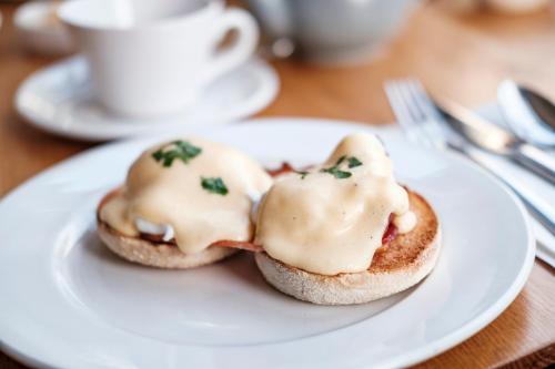 a white plate with two biscuits with icing on them at Albert Arms in Esher