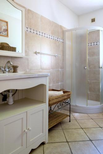 une salle de bain avec un lavabo et une douche dans l'établissement Parasols, à Fréjus
