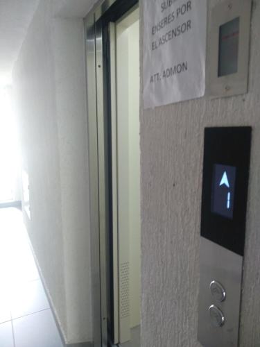 a sign on a wall next to a elevator at Caffeto superstar 706 in Montenegro