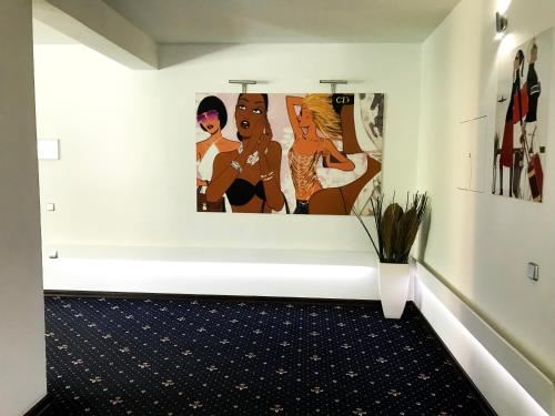 a white room with paintings on the wall at SPA Hotel in Vorzelʼ