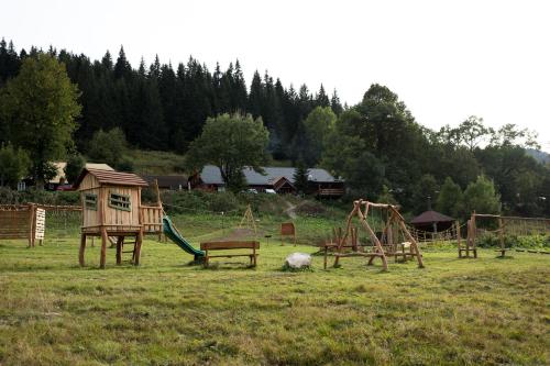 a group of playground equipment in a field at Chata Magurka in Partizánska ľupča