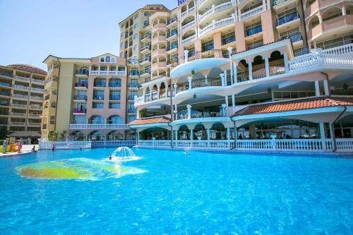 a swimming pool in front of a large building at Royal Park Hotel - All Inclusive in Elenite