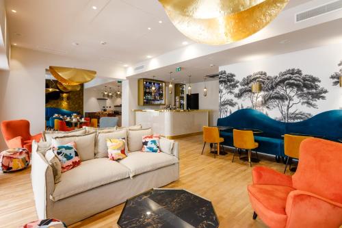 a living room with a couch and chairs at Hotel Verlaine in Cannes