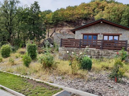 a house on a hill with a garden at Pallas Casa in Panagía